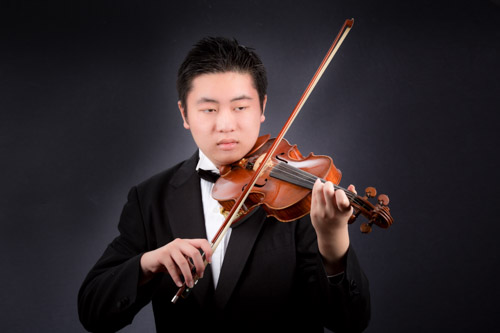 A young Asian senior plays his violin. Hugh Anderson Photography.