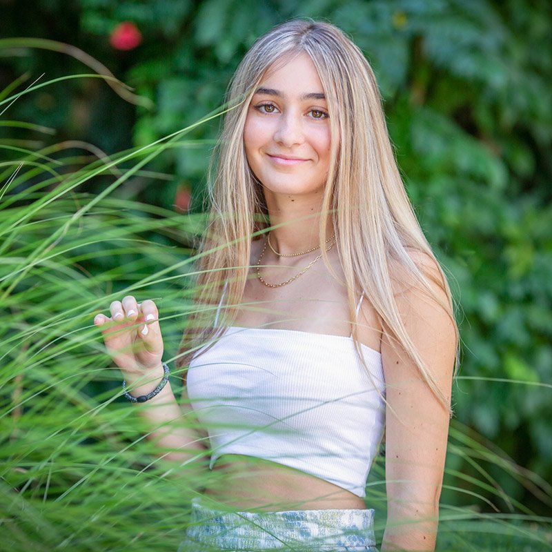 cranbrook-high-school-senior-portrait Cranbrook high school senior student poses in Cranbrook gardens, smiling at the camera
