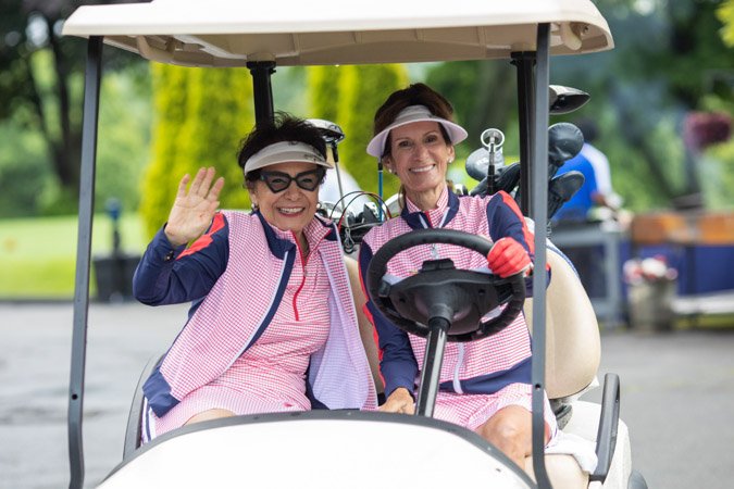 golf-event-photo-birmingham Two ladies in a golf cart at a corporate golf event in Birmingham, Michigan.