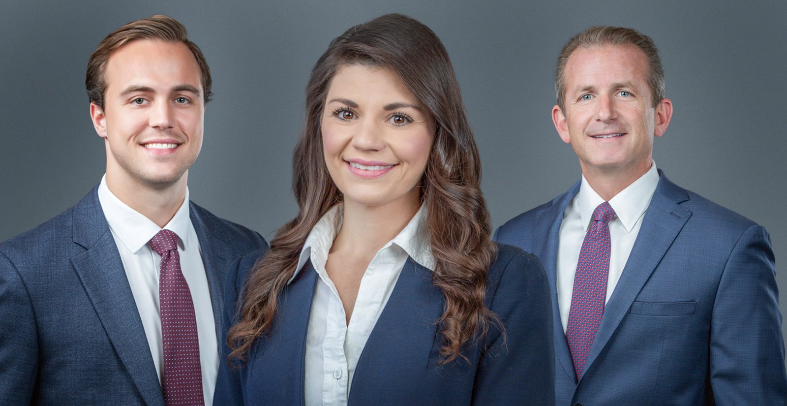 Professional corporate headshots of three business executives in formal attire, captured in a modern studio setting — ideal for company branding, LinkedIn profiles, and team directories.