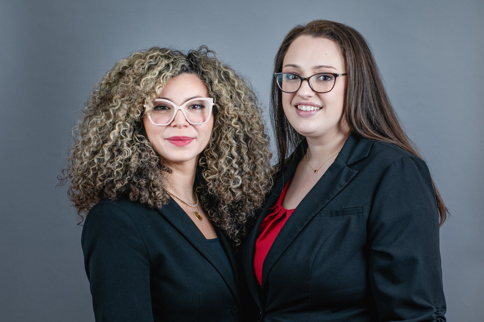 team-headshot-two-lawyers Team headshots at a lawyers office in Livonia. Two female lawyers photographed together