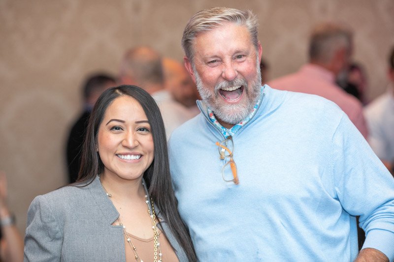 Ally team members smiling at networking reception at Royal Park Hotel in Rochester MI