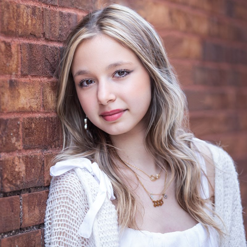 birminghan-senior-portrait High school senior portrait in downtown Birmingham, a girl against a red brick wall.