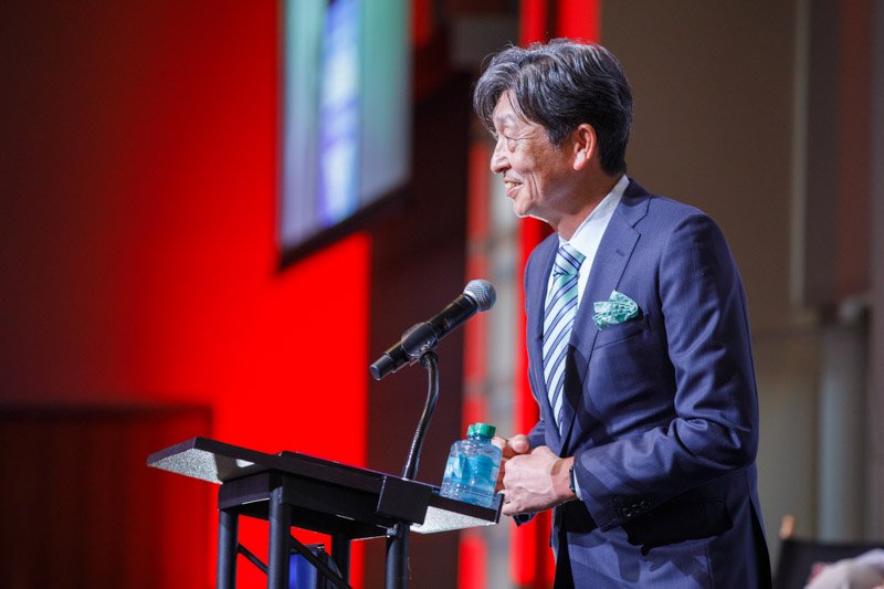 Ted Ogawa, President and CEO of Toyota Motor North America, accepts the 2025 Industry Leadership Award on behalf of Akio Toyoda at SAE International event.