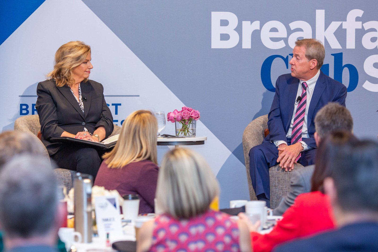 Executive leadership discussion at corporate conference in Birmingham, Michigan.