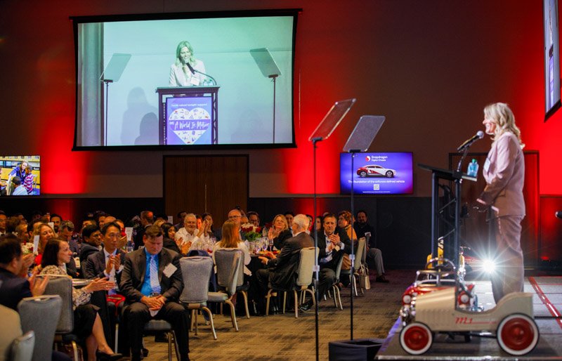 Toyota executive speaking on stage during corporate event in Metro Detroit, photographed by Hugh Anderson.