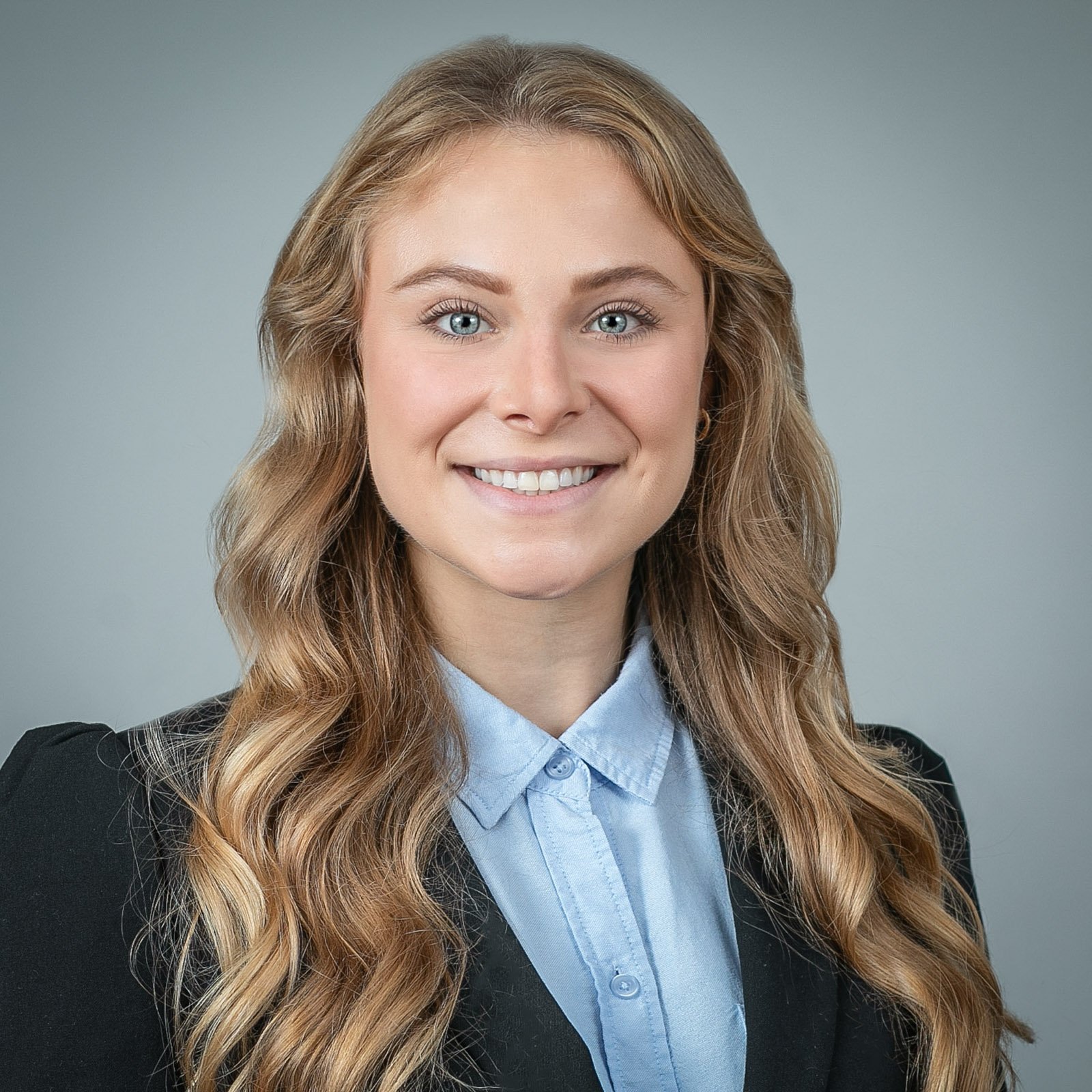 Professional LinkedIn headshot of a woman with natural lighting, photographed in a Metro Detroit studio