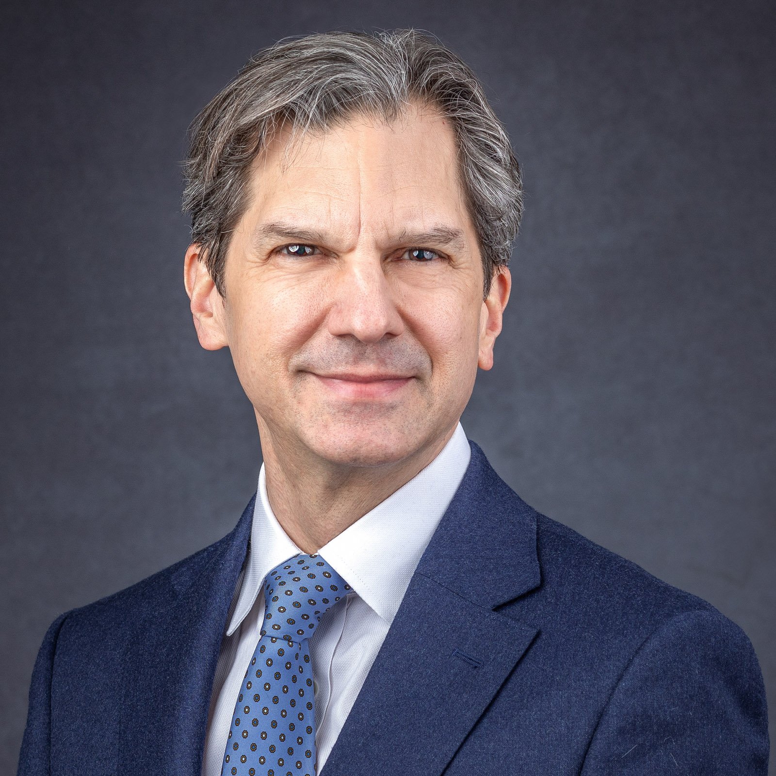 Professional business headshot of a man in a suit, photographed in a Metro Detroit studio for LinkedIn and corporate use