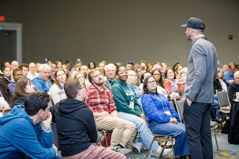 Attendees listening during a corporate conference session