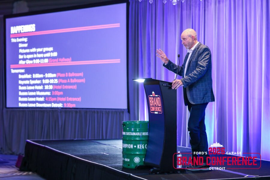 Keynote speaker presenting at a corporate conference in Detroit