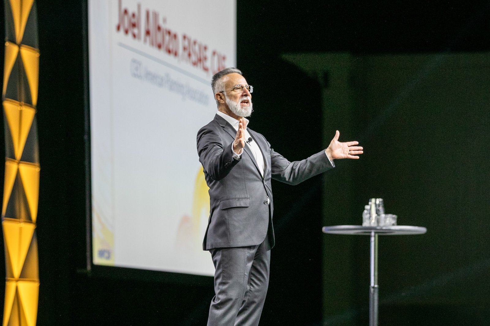 Keynote speaker presenting on stage during a corporate conference at Huntington Place in Detroit, Michigan.