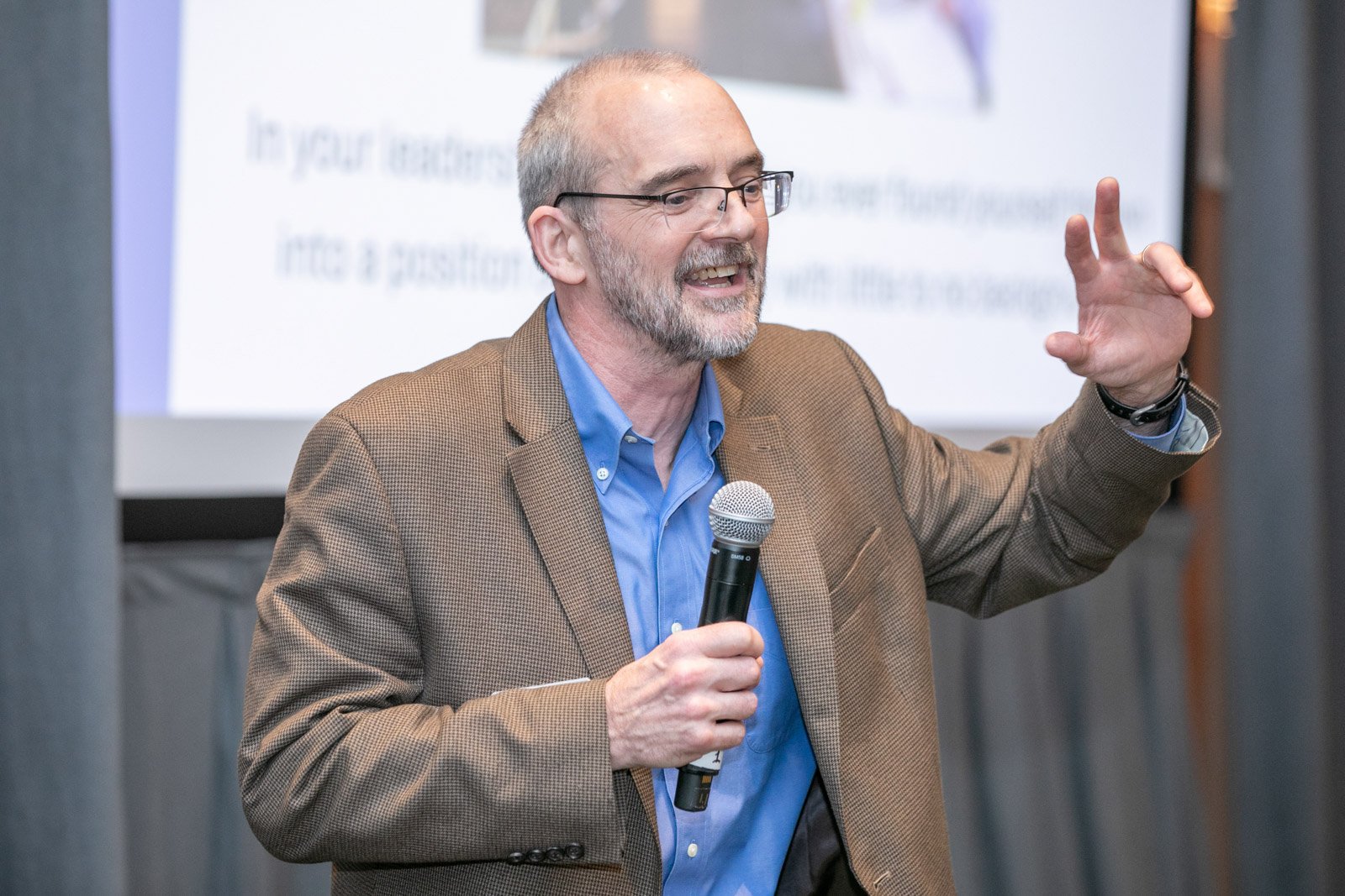 Conference speaker presenting at a corporate event at the Detroit Marriott in downtown Detroit
