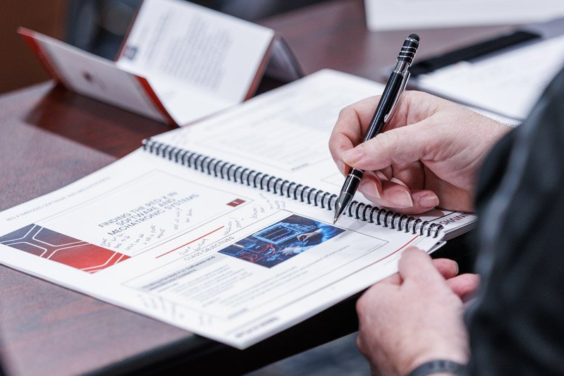 Attendee taking notes during a corporate training and conference session