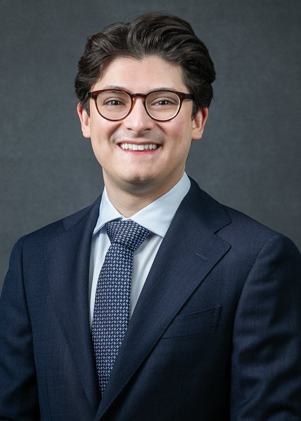 Professional ERAS headshot of a medical residency applicant wearing a black jacket and open-collar white shirt.