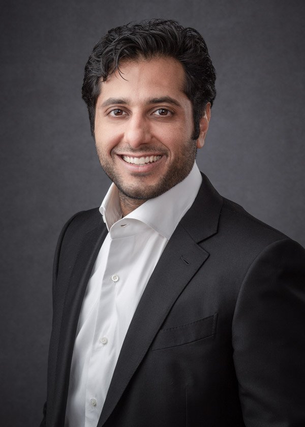 Professional ERAS headshot of a medical residency applicant wearing a black jacket and open-collar white shirt.