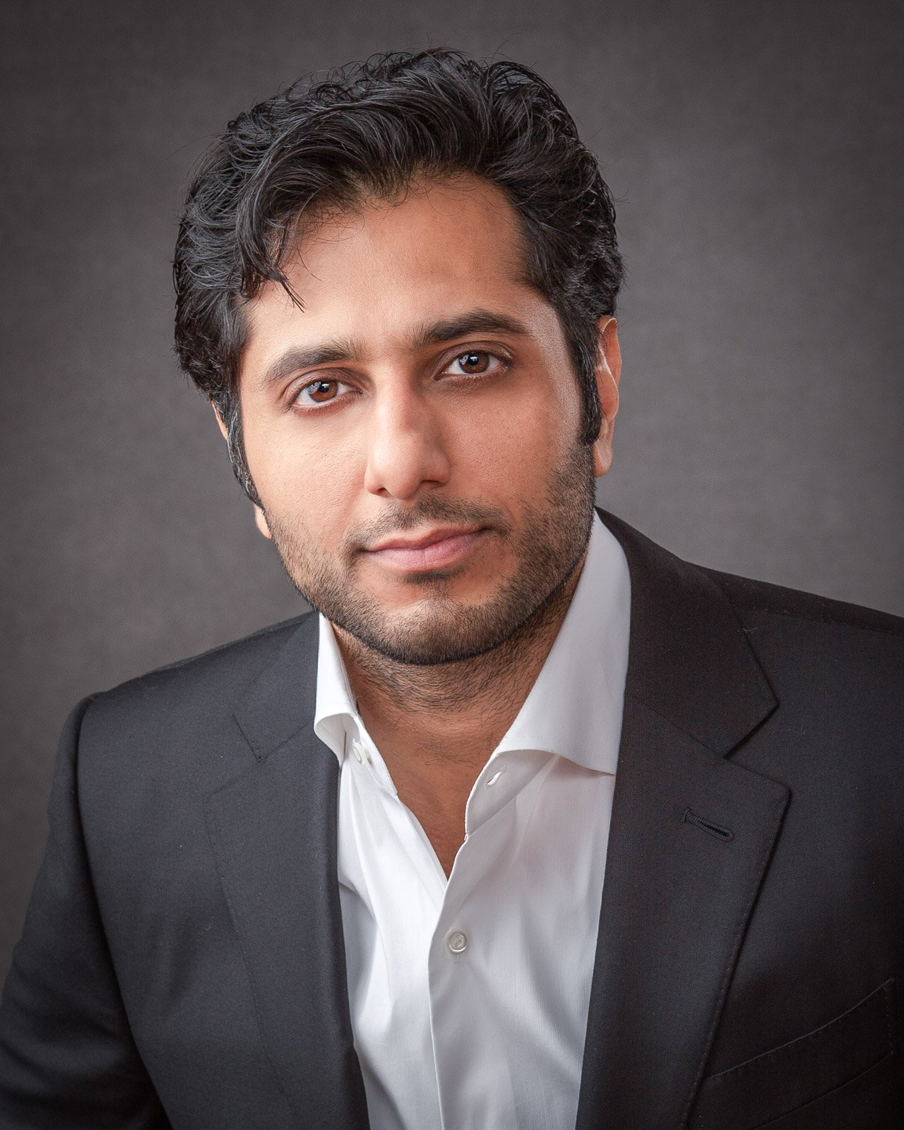 Professional business headshot of a man in a dark suit photographed by Hugh Anderson Photography