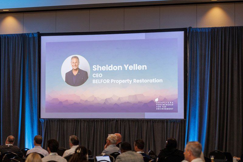 Conference audience viewing the introduction of Sheldon Yellen, CEO of BELFOR Property Restoration, at the SP Innovation Summit.