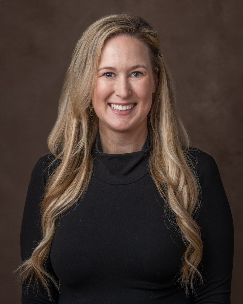 headshot photographed on a brown canvas backdrop