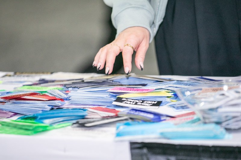Close-up of an attendee interacting with promotional materials at a trade show booth