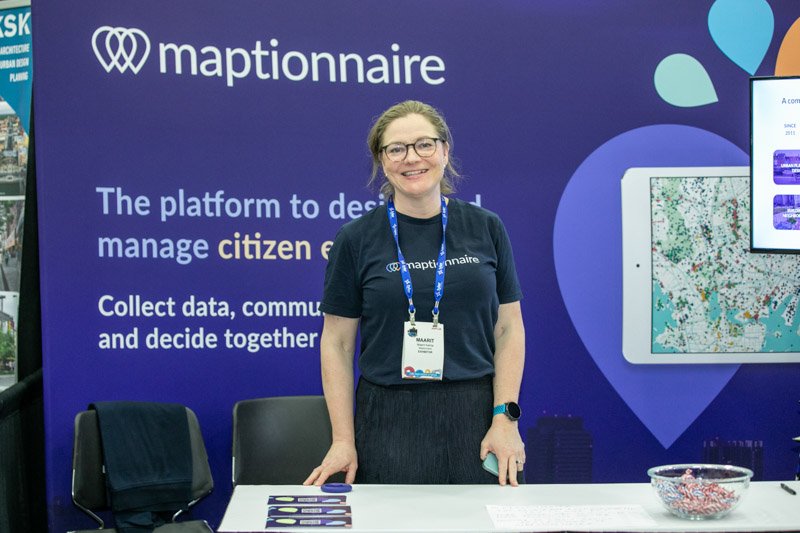 Maptionnaire exhibitors photographed at their branded convention booth