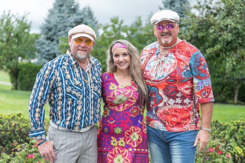 Guests in 1970s themed attire at an Ally Supplier Program event