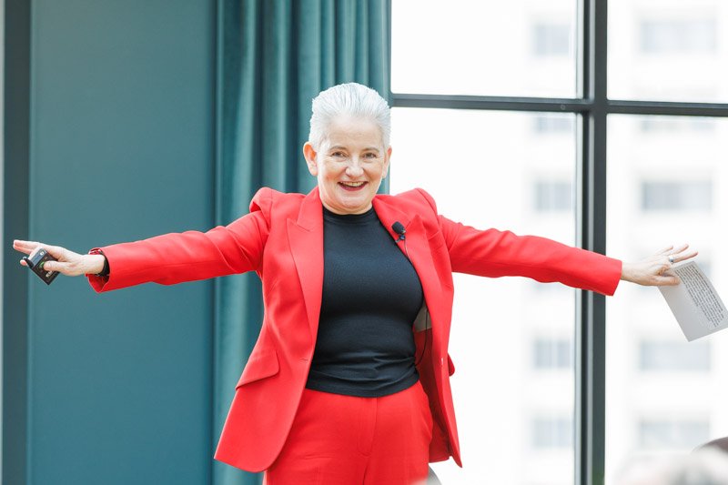 Corporate conference speaker presenting to attendees at a Detroit business event