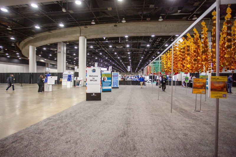 Wide view of the busy APA NPC26 exhibition floor at Huntington Place in Detroit