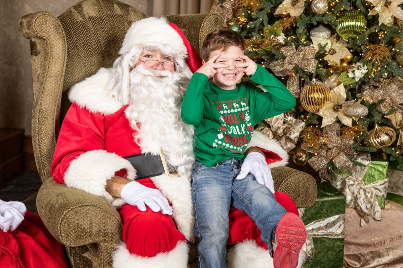 Child with Santa during the MNP Corporation holiday family event at San Marino Club in Troy, Michigan