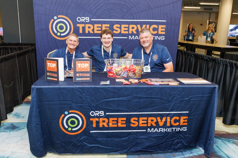 ORB Tree Service exhibitors at their branded trade show booth