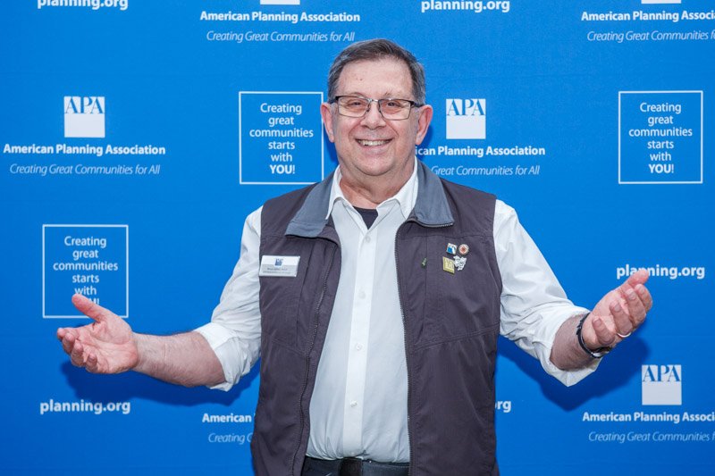 Conference attendee photographed at an American Planning Association step and repeat
