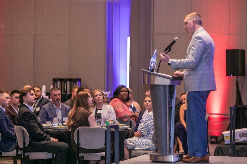 Corporate speaker presenting from the podium at Daxton Hotel