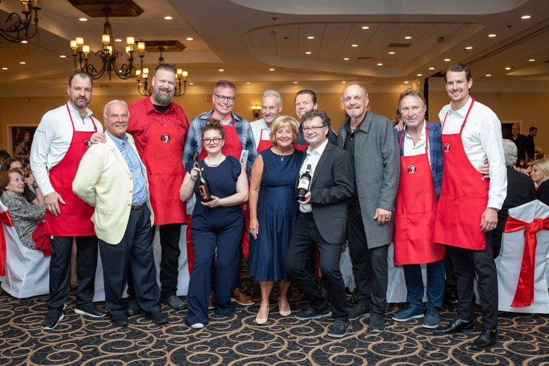 Detroit Red Wings artwork featuring Gordie Howe, Sid Abel and Ted Lindsay displayed at the fundraiser
