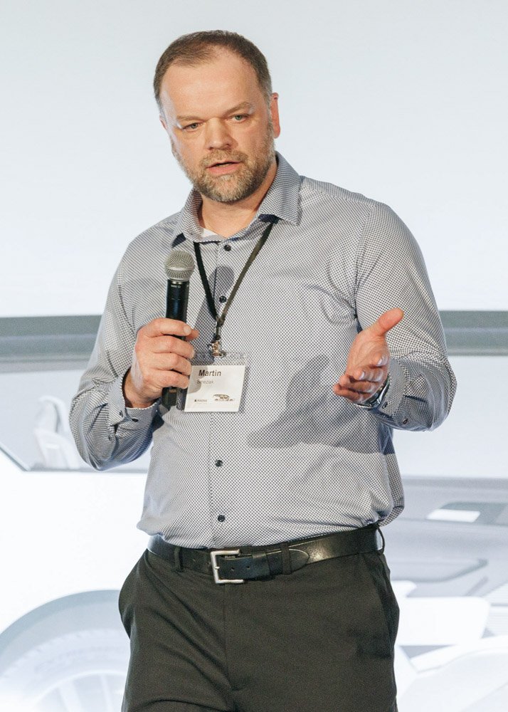 Speaker presenting automotive technology at a Magna Seating corporate conference, photographed by Hugh Anderson Photography. Mobile